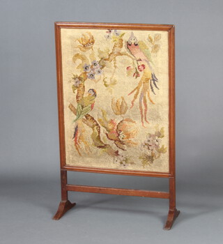 An Edwardian oak fire screen with Berlin woolwork panels, raised on shaped supports 90cm h x 54cm w x 24cm d 
