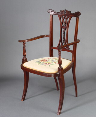 An Edwardian inlaid mahogany pierced vase shaped slat back open armchair with Berlin wool work seat, raised on turned supports 
