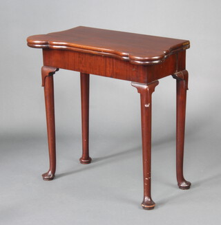 A Georgian shaped mahogany cantilever card table with baise top, fitted candle stands and game counter wells, raised on club supports 73cm h x 77cm w x 38cm d 