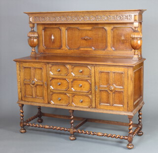 A 1930's light oak Jacobean style carved sideboard with raised back, fitted 3 drawers flanked by a pair of cupboards, raised on spiral turned supports, bun feet 152cm h x 154cm w x 52cm d 