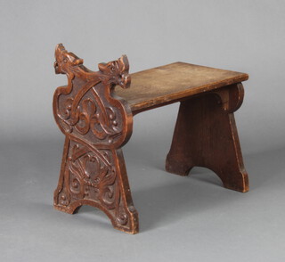 A Victorian carved oak stool with griffin decoration 45cm h x 47cm x 26cm  
