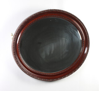 An oval plate wall mirror contained in a decorative mahogany frame 62cm x 75cm 