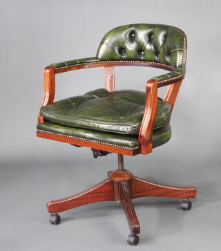 A mahogany framed revolving office chair upholstered in green buttoned leather 