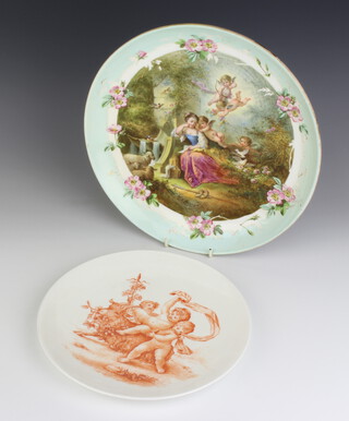 A Continental shallow dish decorated with woodland scene with shepherdess and angels 29cm, a sepia ditto decorated with cupids 24cm 