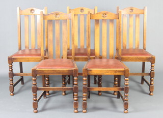 A set of 5 1930's oak stick and rail back dining chairs with arch shaped rail backs and upholstered seats, raised on turned and block supports 
