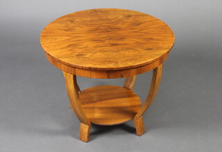 An Art Deco circular walnut 2 tier occasional table with quarter veneered top, raised shaped supports 47cm x 60cm 