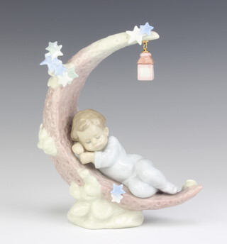 A Lladro  figure of a child sleeping on a half moon beneath a hanging lamp 6479 16cm 