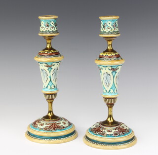 A pair of Doulton Lambeth candlesticks the turquoise ground with classical figures having gilt metal mounts 26cm 