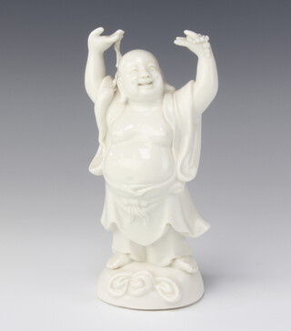 A blanc de chine figure of Hotei holding his hands aloft 18cm  