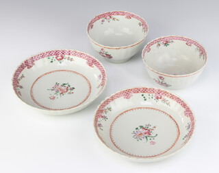 A pair of 18th Century famille rose tea bowls and saucers decorated with flowers 