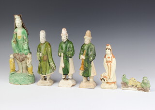 A Chinese slip glazed figure of a dignitary with attendants 26cm, 3 figures of gentleman raised on square bases 19cm, a figure of Guan Yin 15cm and a group of animals 10cm 