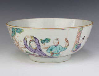An 18th Century Chinese famille rose bowl decorated with figures, dog and a boy holding a bird of prey in an extensive landscape, 26cm  