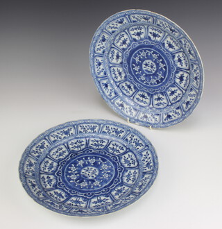 A pair of 18th Century Chinese shallow dishes decorated with panels of flowers 27.5cm 