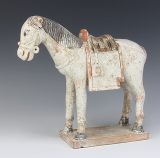 A 17th Century style Chinese unglazed figure of a horse raised on a rectangular base 25cm 