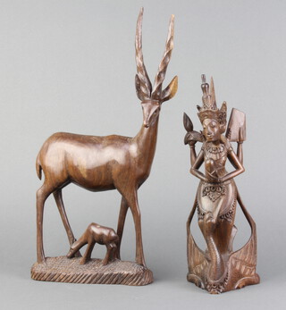 A carved Eastern hardwood figure of a Deity 28cm x 10cm x 7cm together with a carved hardwood figure of a gazelle 36cm x 15cm x 6cm (slight chip to antler) 