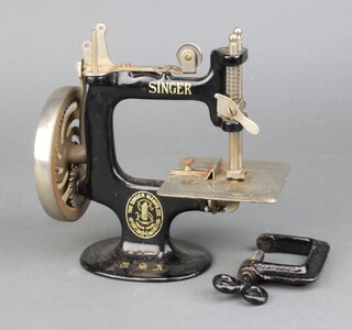 A child's Singer USA sewing machine with clamp 
