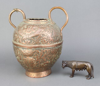 A bronze figure of a standing She Wolf 6cm x 9cm x 2cm together with an embossed copper twin handled urn 20cm x 14cm 