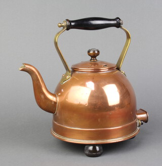 An early copper electric kettle with turned wooden handle
