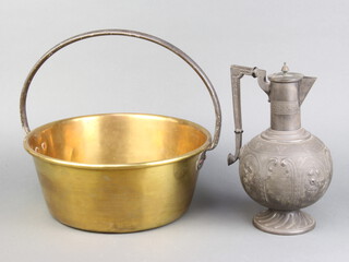 A brass preserving pan with iron handle 12cm x 32cm together with a Art Nouveau embossed Britannia metal hot water jug 27cm (slightly bent) 