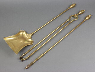 A Victorian brass Adam style 3 piece fireside companion set, all with lidded urn finials