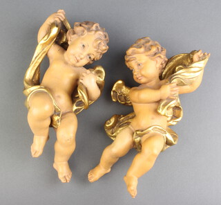 A pair of carved limewood figures of cherubs 22cm x 10cm 