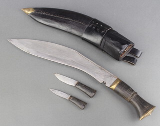 A Kukri with horn grip, 2 skinning knives and leather scabbard 
