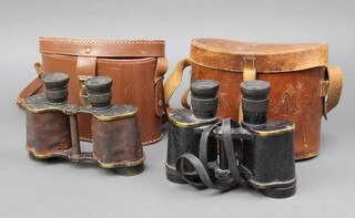 A pair of military issue binoculars with crows foot mark, marked ND 16 NP 17 (chip to eye piece) together with a pair of Bino Prism No.2 Mk 3 binoculars marked 1945 Graticules half apart, both with associated carrying cases 