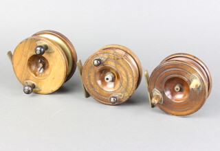 Three 19th Century wooden and brass star back centre pin fishing reels 11cm, 10cm and 10cm 