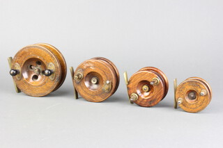 A 19th Century wooden and brass centre pin fishing reel and 3 others 11cm, 9cm, 7cm and 6cm (1 with repair)