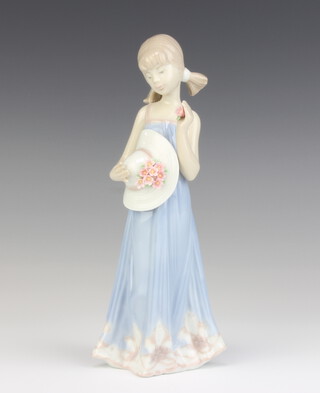 A Lladro figure of a young lady with a bonnet 5648 21cm 