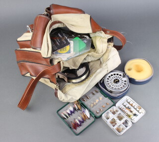 A canvas fishing bag containing Ryobi 355 centre pin fly reel, a Wheatley metal fly box, two plastic fly boxes etc 