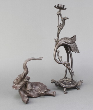 A Japanese bronze candlestick in the form of a stork standing on a turtle 33cm x 11cm x 9cm together with a spelter figure of a reclining elephant 16cm x 13cm x 10cm 