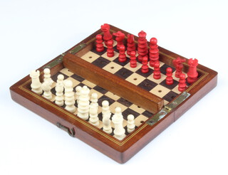 A 19th Century inlaid mahogany travelling chess set with turned ivory pieces (1 red bishop missing) 
 