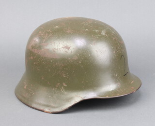 A German steel helmet complete with liner interior marked 64 