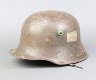 A German steel helmet marked T166 with part liner and no strap