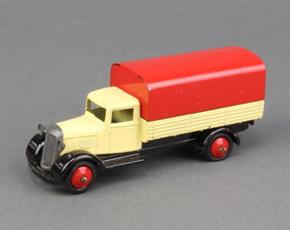 Dinky a 1948/50 covered wagon (25b) with cream body, black moulded chassis, red cover and red hubs