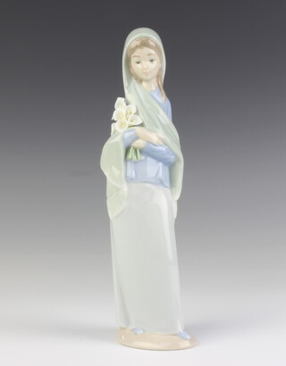 A Lladro figure of a girl holding a bunch of lilies 24cm 