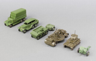 Dinky military models consisting of an anti-aircraft gun on trailer (161b) in gloss green with gloss baseplate, a 1947-50 Light tank (152a), a 1947-54 6-wheel covered wagon (151b) with seat holes and ridged hubs, a 1947-40 Reconnaissance Car (152b) with ridged hubs.