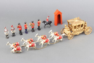 An Elizabeth II model of The Coronation coach with horses together with a 4 piece band, 2 dismounted lifeguards, a mounted cavalryman and a metal sentry box  