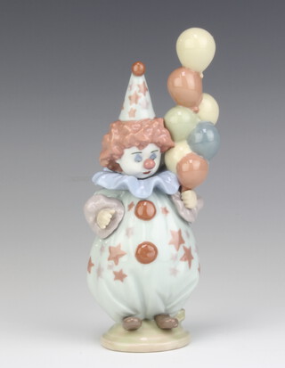 A Lladro figure of a child clown holding balloons 5811 18cm 