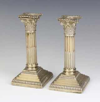 A pair of Edwardian Corinthian column silver candlesticks, London 1901, 17cm 