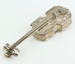 A Victorian repousse silver box in the form of a violin decorated with figures, import marks London 1899, 8.5cm, 30 grams 