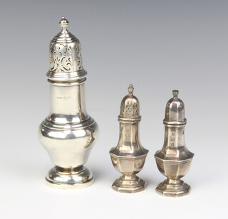A Queen Anne style silver sugar shaker Chester 1926 17cm and a pair of silver octagonal condiments Birmingham 1978, 222 grams 