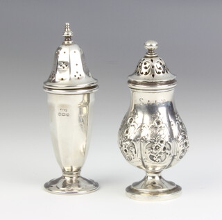 A Victorian repousse silver baluster pepper with floral decoration, London 1884, an octagonal tapered ditto Sheffield 1959, 115 grams