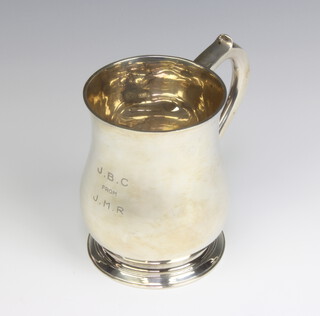 A Georgian design silver baluster mug with presentation inscription, London 1934, 12.5cm, 410 grams 