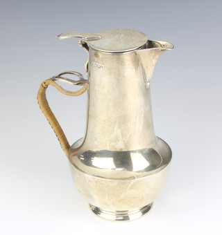A stylish silver hot water jug with woven handle and armorial, Sheffield 1924, 19cm, gross weight 447 grams 
