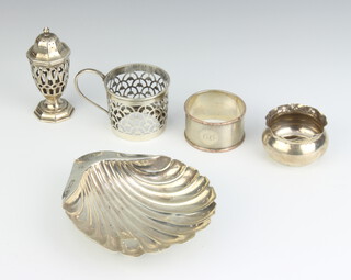 A silver shell shaped butter dish, Sheffield 1920, pepper, holder, napkin ring and salt, 150 grams 