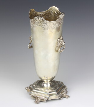 A silver vase with scroll rim and lion ring handles raised on claw feet, 28cm, Birmingham 1926, 721 grams