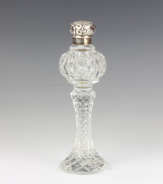 An Edwardian style silver mounted cut glass scent with waisted stem and repousse lid, 11cm 