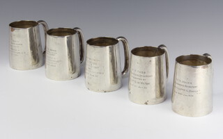 A set of 5 matched silver mugs with presentation inscriptions 770 grams